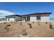 Charming single-story home featuring a three car garage, desert landscaping, and a modern front door at 2900 W Jaybird St, Pahrump, NV 89048