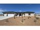 Charming single-story home featuring a three car garage, desert landscaping, and a modern front door at 2900 W Jaybird St, Pahrump, NV 89048