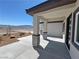 Inviting front porch with stone columns, contemporary lighting and modern door at 2900 W Jaybird St, Pahrump, NV 89048