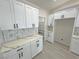 Modern kitchen featuring white cabinets, a view into the pantry, and sleek countertops at 2900 W Jaybird St, Pahrump, NV 89048