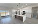Bright, modern kitchen with a kitchen island, stainless steel appliances, and modern hanging lamps at 2900 W Jaybird St, Pahrump, NV 89048