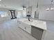Modern kitchen island with a white countertop and sink, with views to a fireplace in the living room at 2900 W Jaybird St, Pahrump, NV 89048