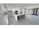 Bright kitchen with white cabinets, stainless steel appliances, and a large kitchen island at 2900 W Jaybird St, Pahrump, NV 89048