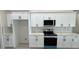 Modern kitchen featuring white cabinets, stainless steel appliances, and sleek countertops at 2900 W Jaybird St, Pahrump, NV 89048