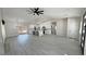 Open-concept living room with modern kitchen, lots of light, and wood tile floors at 2900 W Jaybird St, Pahrump, NV 89048