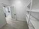 A view of a walk-in pantry with shelving and access to the kitchen, showcasing storage at 2900 W Jaybird St, Pahrump, NV 89048