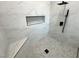 Modern shower featuring marble tile, built-in niche, and rainfall showerhead at 2900 W Jaybird St, Pahrump, NV 89048