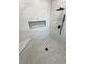 Modern shower features gray tile flooring, built-in niche, bench, and a rainfall shower head at 2900 W Jaybird St, Pahrump, NV 89048