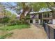 Charming home with lush backyard, mature trees, balcony, patio, and meticulous landscaping, providing a serene outdoor space at 2935 Pinehurst Dr, Las Vegas, NV 89109