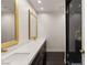 Bathroom features a double sink vanity, gold-framed mirrors, and a glass-enclosed shower at 2935 Pinehurst Dr, Las Vegas, NV 89109