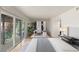 Well-lit bedroom with desk, shelving, and sliding glass doors to private balcony at 2935 Pinehurst Dr, Las Vegas, NV 89109