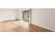 Bright, empty bedroom with wood floors and sliding glass doors to a private balcony at 2935 Pinehurst Dr, Las Vegas, NV 89109