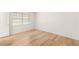 Bright bedroom featuring a window with blinds and light wood flooring at 2935 Pinehurst Dr, Las Vegas, NV 89109