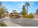 Elegant gated entrance to Las Vegas Country Club Estates, with stone guardhouse, manicured landscaping, and palm trees at 2935 Pinehurst Dr, Las Vegas, NV 89109