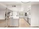 Bright and spacious kitchen with a breakfast bar, stainless steel appliances, and wood-look tile flooring at 2935 Pinehurst Dr, Las Vegas, NV 89109