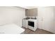 Laundry room featuring a front loading washer and dryer and overhead storage at 2935 Pinehurst Dr, Las Vegas, NV 89109