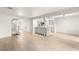 Open concept: Living room flows to kitchen, showcasing the breakfast bar, new tile flooring, and stairs at 2935 Pinehurst Dr, Las Vegas, NV 89109