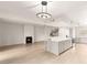 Spacious open-concept living room featuring a fireplace, breakfast bar and modern lighting at 2935 Pinehurst Dr, Las Vegas, NV 89109