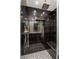 Sleek shower stall featuring dark tiles, modern fixtures, and built-in bench at 2935 Pinehurst Dr, Las Vegas, NV 89109