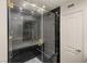 Contemporary shower with frameless glass door, gray tiling, and rainfall shower head at 2935 Pinehurst Dr, Las Vegas, NV 89109