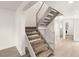 Bright staircase with carpeted steps and white railing, leading to the upper level of the home at 2935 Pinehurst Dr, Las Vegas, NV 89109