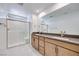 Modern bathroom featuring a double vanity, a glass-enclosed shower, and marble-tiled flooring at 3359 Via Tizzoni St, Henderson, NV 89044
