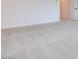 Spacious bedroom with gray carpeting, white walls, and a door, creating a serene and inviting space at 3359 Via Tizzoni St, Henderson, NV 89044