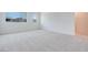 Bright and airy bedroom with plush gray carpeting and lots of natural light streaming in through the windows at 3359 Via Tizzoni St, Henderson, NV 89044