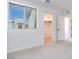 Bright bedroom featuring neutral carpet, walk-in closet, and a large window providing ample natural light at 3359 Via Tizzoni St, Henderson, NV 89044