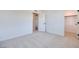 Spacious bedroom with neutral carpet, white walls, and ample natural light streaming in from a window at 3359 Via Tizzoni St, Henderson, NV 89044