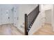 Bright entryway showcasing light wood floors, white walls, a modern front door, and a carpeted staircase at 3359 Via Tizzoni St, Henderson, NV 89044
