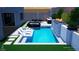 Backyard pool featuring a spa, waterfall, outdoor kitchen, and a lounge area for relaxation and entertaining at 365 Crown Mesa Ave, Las Vegas, NV 89138