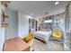 Bright bedroom with floral wallpaper, a hanging chair, modern lighting, and a dedicated desk/study area at 365 Crown Mesa Ave, Las Vegas, NV 89138