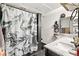 Bathroom features a marble vanity, a shower with marble tiles, and bright lighting at 3774 Decade St, Las Vegas, NV 89121