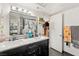Bathroom features a dual sink vanity with a dark cabinet base and updated lighting at 3774 Decade St, Las Vegas, NV 89121
