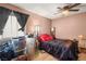 This bedroom has wood floors, window, and ceiling fan at 3774 Decade St, Las Vegas, NV 89121