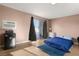 Cozy bedroom with a sliding glass door, min-fridge, and window air conditioner at 3774 Decade St, Las Vegas, NV 89121