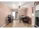 Cozy dining area features wood floors, ceiling fan, small table with 4 chairs, and a sliding glass door at 3774 Decade St, Las Vegas, NV 89121