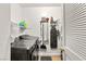 Laundry room with washer and dryer, cleaning supplies, and storage hooks on the wall at 3774 Decade St, Las Vegas, NV 89121