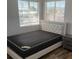Bedroom with large window, a new mattress, and modern bedside table at 4454 Bertram Ln, Las Vegas, NV 89147