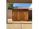 Neatly designed wooden enclosure discreetly houses outdoor equipment in the backyard at 4454 Bertram Ln, Las Vegas, NV 89147