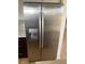 Stainless steel refrigerator in a kitchen with tiled backsplash and wood cabinets at 4454 Bertram Ln, Las Vegas, NV 89147