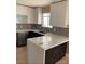 Bright kitchen offers lots of quartz countertop space and stainless steel dishwasher at 4454 Bertram Ln, Las Vegas, NV 89147