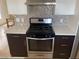 Updated kitchen features stainless steel appliances and a modern tile backsplash at 4454 Bertram Ln, Las Vegas, NV 89147