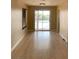 Bright living room with wood floors, large sliding doors, and access to the backyard pool at 4454 Bertram Ln, Las Vegas, NV 89147