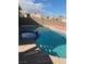 In-ground swimming pool with spa, steps, and surrounding patio offering a relaxing outdoor retreat at 4454 Bertram Ln, Las Vegas, NV 89147