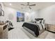 Stylish bedroom with a modern ceiling fan, plantation shutters, and textured wallpaper at 4576 Amazing View St, Las Vegas, NV 89129