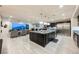 A spacious kitchen with a large island, stainless steel appliances, and an adjacent living area at 4576 Amazing View St, Las Vegas, NV 89129