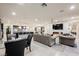 Open-concept living room with tile floors, a dining area, and a kitchen with an island and bar stools at 4576 Amazing View St, Las Vegas, NV 89129
