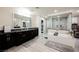Lavish bathroom featuring dual vanities, a freestanding tub, and a glass-enclosed shower with mosaic tile at 4576 Amazing View St, Las Vegas, NV 89129